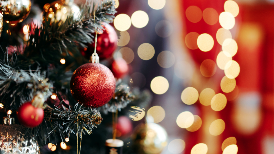 Christmas Tree Close-Up with a Backdrop of Festive Colors - Corporate Christmas Gifts in Australia